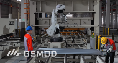 GS MOD factory workers and automated equipment during steel processing for modular building production.